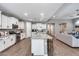 Modern kitchen with stainless steel appliances and granite countertops overlooking the living area at 35773 N Loemann Dr, San Tan Valley, AZ 85143