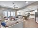 Bright living room open to kitchen with tile floors, plush seating and ample natural light at 35773 N Loemann Dr, San Tan Valley, AZ 85143