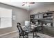 Comfortable office space with built-in shelving, desk, and ceiling fan at 35773 N Loemann Dr, San Tan Valley, AZ 85143