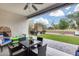 Back patio featuring covered seating area and artificial turf with a green space for entertaining at 35773 N Loemann Dr, San Tan Valley, AZ 85143