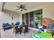 Covered patio with a ceiling fan for cooling, outdoor seating, and convenient access to the kitchen at 35773 N Loemann Dr, San Tan Valley, AZ 85143
