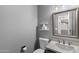 Cozy half-bathroom with a pedestal sink, toilet and mirrored cabinet; perfect for guests at 3822 E Florian Ave, Mesa, AZ 85206