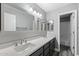 Bright bathroom with a double sink vanity, large mirrors, and modern lighting fixtures at 3822 E Florian Ave, Mesa, AZ 85206