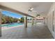 Large, covered patio overlooking the sparkling pool and lush backyard at 3822 E Florian Ave, Mesa, AZ 85206