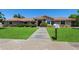 Inviting single-story home boasting a well-manicured front lawn, desert landscaping, and a charming walkway at 3822 E Florian Ave, Mesa, AZ 85206