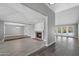 Open-concept living room with modern flooring, a cozy brick fireplace, and an abundance of natural light at 3822 E Florian Ave, Mesa, AZ 85206
