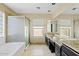 This bathroom features a double sink vanity, walk-in shower and tub at 4107 W Mariposa Grande --, Glendale, AZ 85310