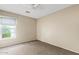 Bedroom with plush carpet, standard closet, ceiling fan, and window at 4107 W Mariposa Grande --, Glendale, AZ 85310