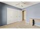 Bedroom with plush carpet, large closet with folding doors, and ceiling fan at 4107 W Mariposa Grande --, Glendale, AZ 85310
