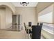 Open dining area features stainless steel refrigerator and a modern dining set at 4107 W Mariposa Grande --, Glendale, AZ 85310