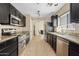 Kitchen with stainless steel appliances and granite countertops that opens to the dining room at 4107 W Mariposa Grande --, Glendale, AZ 85310