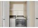 A bright laundry closet with a modern washer and dryer at 4107 W Mariposa Grande --, Glendale, AZ 85310