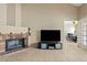 Comfortable living room with brick fireplace, tiled floors and modern entertainment center at 4107 W Mariposa Grande --, Glendale, AZ 85310