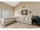 Living room featuring vaulted ceilings, tiled floors, and a large sectional sofa, perfect for entertaining at 4107 W Mariposa Grande --, Glendale, AZ 85310