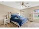 Bedroom featuring carpet, windows, ceiling fan, and coordinated decor, creating a calming retreat at 4107 W Mariposa Grande --, Glendale, AZ 85310