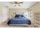 Bedroom featuring carpet, windows, ceiling fan, and coordinated decor, creating a calming retreat at 4107 W Mariposa Grande --, Glendale, AZ 85310