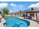 Stunning pool features a baja step, pergola, solar panels, and ample patio space at 4107 W Mariposa Grande --, Glendale, AZ 85310