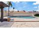 Inviting pool with travertine deck, palm trees, and a covered pergola creates an outdoor oasis at 4107 W Mariposa Grande --, Glendale, AZ 85310