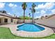 Inviting backyard pool featuring a baja shelf, lush landscaping, and outdoor kitchen with pergola at 4107 W Mariposa Grande --, Glendale, AZ 85310