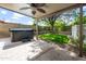 Inviting covered patio area with hot tub and lush landscaped yard at 4226 E Stanford Ave, Gilbert, AZ 85234