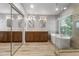 Modern bathroom features double sinks, a freestanding tub, and a glass-enclosed shower at 4226 E Stanford Ave, Gilbert, AZ 85234