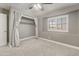 Bedroom with large window, ceiling fan, neutral walls, and carpet at 4226 E Stanford Ave, Gilbert, AZ 85234