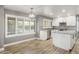Stylish kitchen includes stainless steel appliances, an island, white cabinets and abundant natural light at 4226 E Stanford Ave, Gilbert, AZ 85234