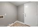 Neutral laundry room with vinyl floors, utility hookups, and access door at 4226 E Stanford Ave, Gilbert, AZ 85234