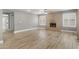Spacious living room with wood flooring, brick fireplace, and modern ceiling fan at 4226 E Stanford Ave, Gilbert, AZ 85234