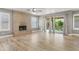 Bright living room with wood flooring, brick fireplace, and access to backyard at 4226 E Stanford Ave, Gilbert, AZ 85234