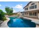 Sparkling pool features a rock waterfall and a diving board, perfect for summer fun at 4226 E Stanford Ave, Gilbert, AZ 85234