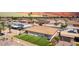 Aerial view of the backyard, showing a lush lawn, patio area, and surrounding neighborhood at 4655 E Farmdale Ave, Mesa, AZ 85206