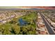 Expansive aerial view of a golf course community with lush green fairways and water features, set against a backdrop of mountains at 4655 E Farmdale Ave, Mesa, AZ 85206