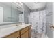 This bathroom features a vanity, toilet, shower with tub, and a decorative curtain at 4655 E Farmdale Ave, Mesa, AZ 85206