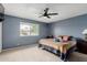 Bedroom with a ceiling fan, neutral carpet, and a window, providing comfortable living space at 4655 E Farmdale Ave, Mesa, AZ 85206