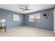 This bedroom features neutral carpet, a window, and blue walls at 4655 E Farmdale Ave, Mesa, AZ 85206