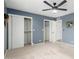 This bedroom features blue walls, neutral carpet, and built-in closets at 4655 E Farmdale Ave, Mesa, AZ 85206