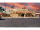 The Sunland Village clubhouse featuring a red tile roof and ample parking at 4655 E Farmdale Ave, Mesa, AZ 85206