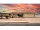 A quaint single-story home featuring charming brickwork, a two-car garage and well-maintained landscaping at 4655 E Farmdale Ave, Mesa, AZ 85206