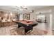 Open-concept game room featuring a pool table and bar seating to the kitchen for entertaining at 4655 E Farmdale Ave, Mesa, AZ 85206