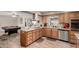 Functional kitchen with stainless steel appliances, island with barstool seating, and wood cabinetry at 4655 E Farmdale Ave, Mesa, AZ 85206