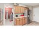 Bright kitchen with stainless steel refrigerator, granite countertops, and adjacent laundry room at 4655 E Farmdale Ave, Mesa, AZ 85206