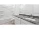 Bathroom features a granite countertop, tiled floor, white vanity and fixtures, plus a tub with shower at 469 W Bunker Hill St, Florence, AZ 85132