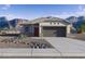 Charming single-story home with desert landscaping and mountain views, showcasing Southwestern living at 469 W Bunker Hill St, Florence, AZ 85132
