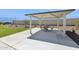Community ramada features a metal roof, stone columns and furniture offering shaded gathering space at 469 W Bunker Hill St, Florence, AZ 85132