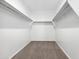 Empty walk-in closet with neutral carpeting and shelving at 469 W Bunker Hill St, Florence, AZ 85132