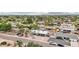 Aerial view of a home with a pool, nestled in a lush neighborhood with mountain views at 5119 E Shaw Butte Dr, Scottsdale, AZ 85254