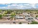 Aerial view of a home with a pool, nestled in a lush neighborhood with mountain views at 5119 E Shaw Butte Dr, Scottsdale, AZ 85254