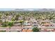 High angle aerial of home in the neighborhood with lush trees and mountain views at 5119 E Shaw Butte Dr, Scottsdale, AZ 85254