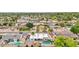 This aerial shot highlights a home with a private pool and patio, nestled in a neighborhood with mature trees at 5119 E Shaw Butte Dr, Scottsdale, AZ 85254